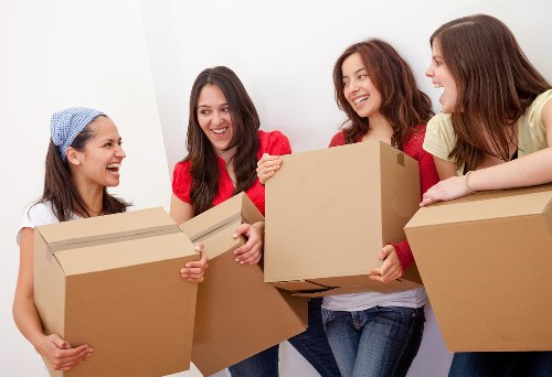 Professional movers handling furniture and boxes during a Fulham relocation