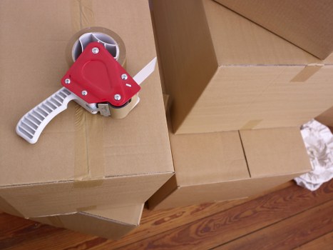Removal workers dismantling furniture inside a Fulham property