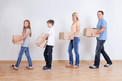 Removal team carrying furniture during a Fulham home move